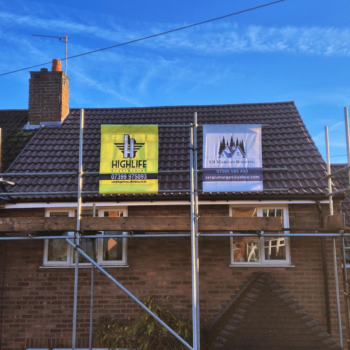 Charcoal tile re-roof in progress on scaffolding, SB Margan Roofing banner, Birmingham